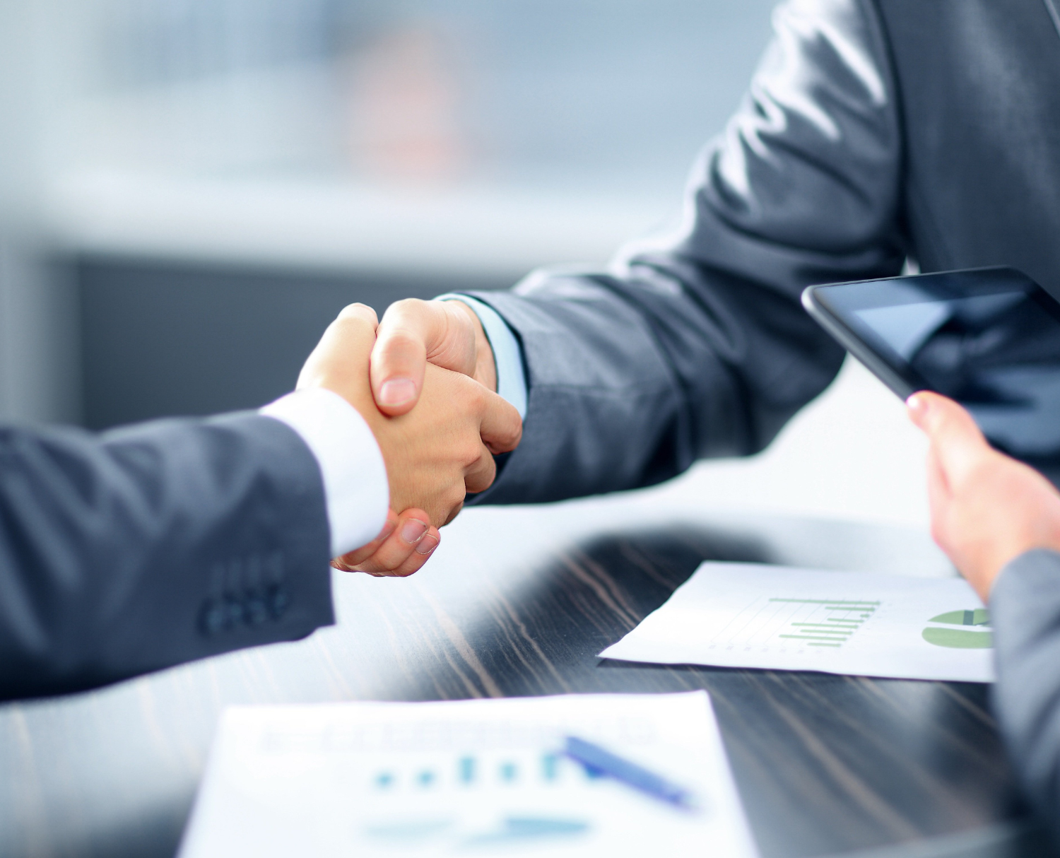 Business handshake at a large bank symbolizing partnership and trust